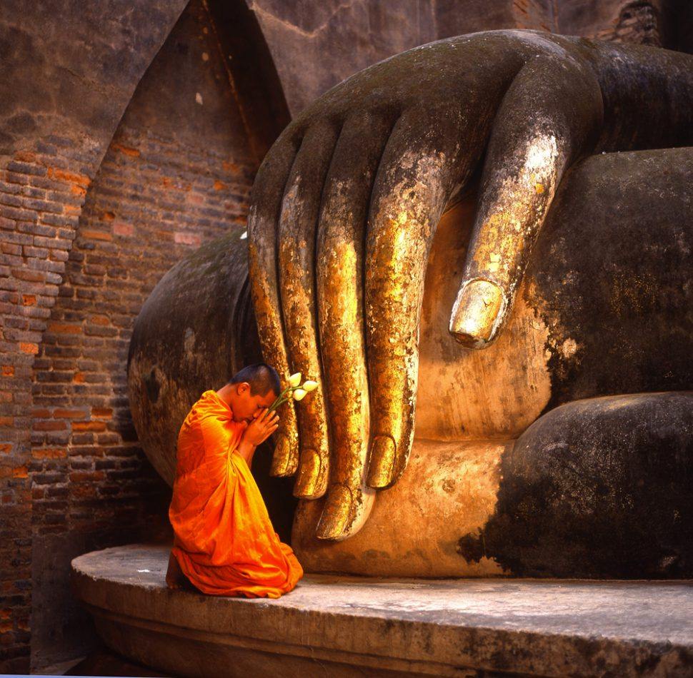 Thailand Tourism - Young Monk Praying in Si Chum Temple, Sukhothai Historical Park, Sukhothai, Thailand-00006805
