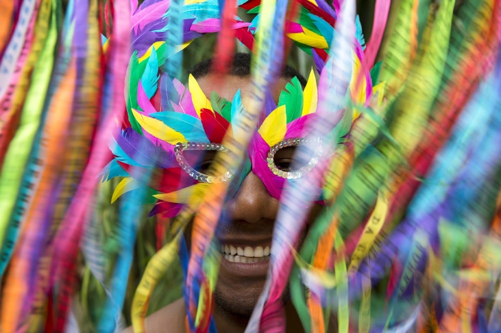 Smiling Brazilian man in colourful mask at Carnival in Rio, Brazil