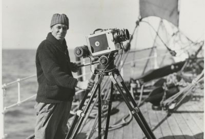 Captain Frank Hurley with a camera on board the Discovery, circa 1931