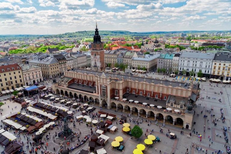 Market Square with Cloth Hall and City Hall Tower in Krakow, Poland Trip