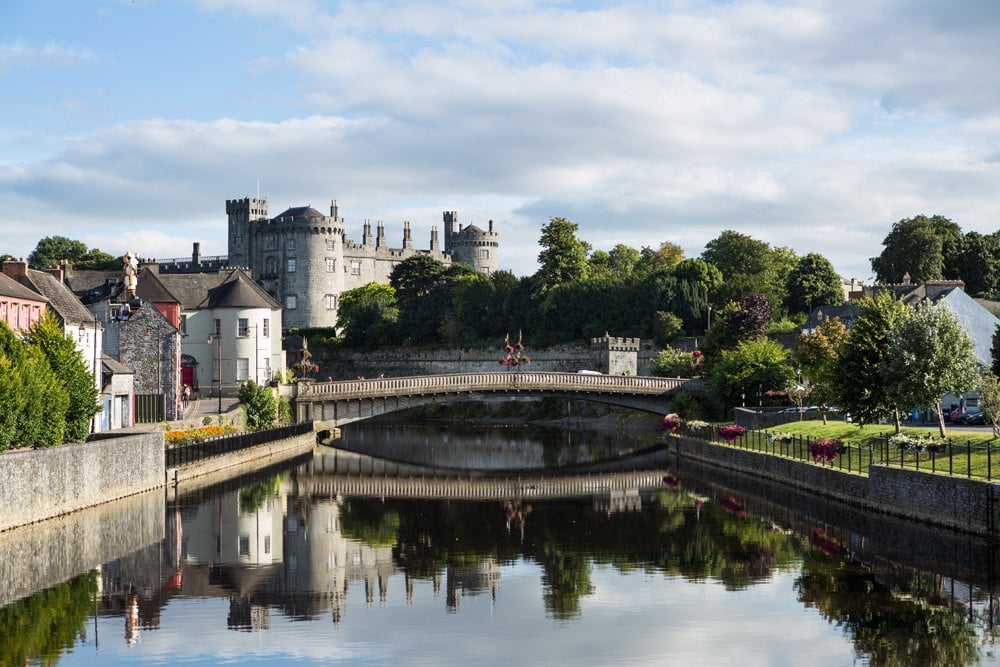Riverside view of Kilkenny Castle, town and bridge, Ireland 