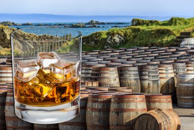 Scotch glass and whisky barrels lined up seaside on the Island of Islay, Scotland UK (United Kingdom)