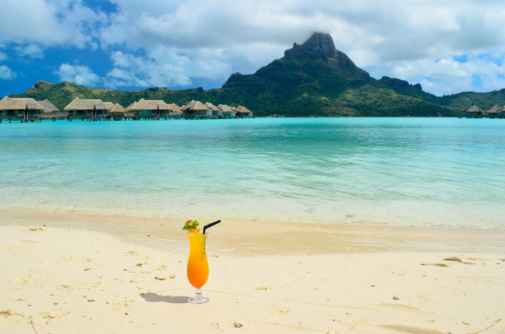 Sex on the Beach cocktail on beach of resort with view of Bora Bora in Tahiti (French Polynesia)