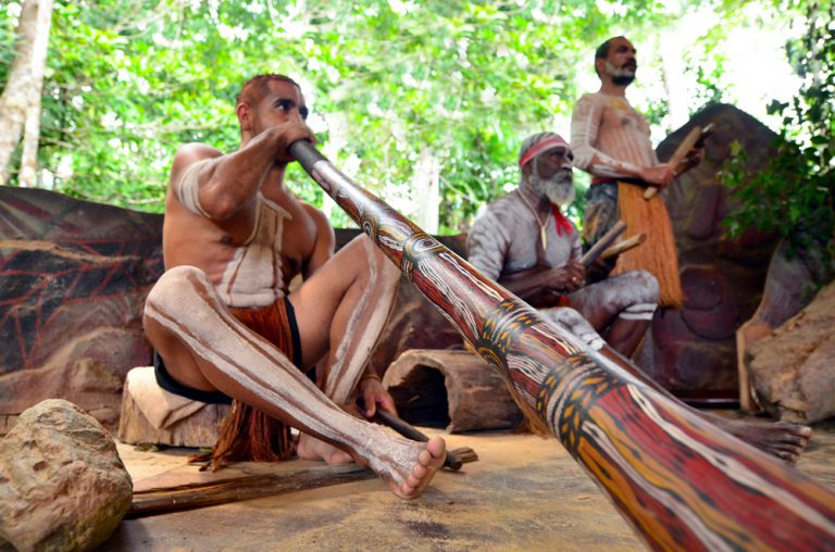 Yirrganydji Aboriginal men play didgeridoo and wooden instrument at culture show, Queensland, Australia
