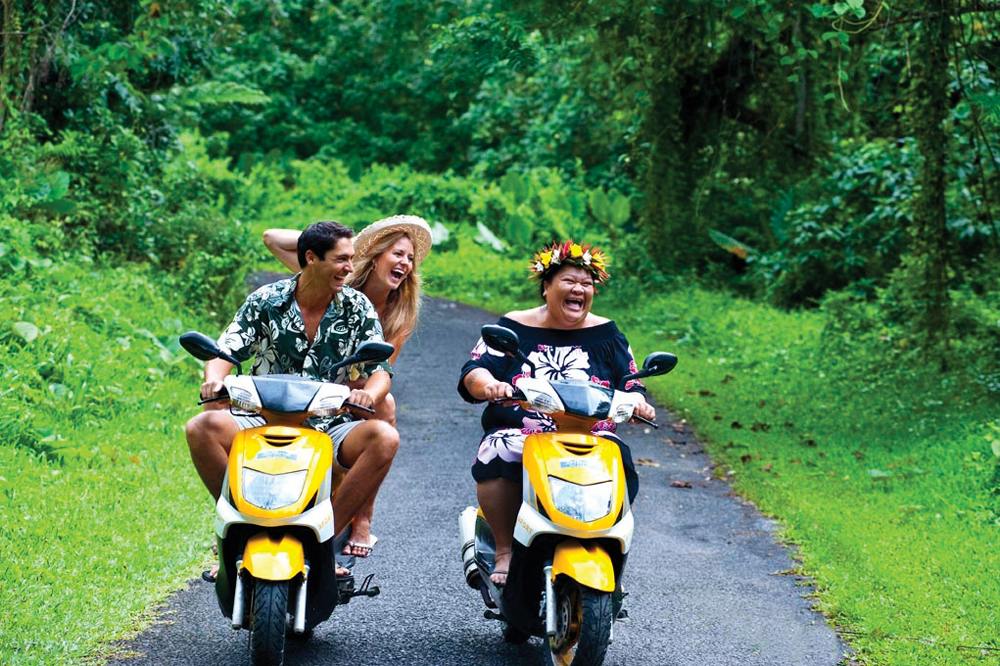 Locals get around scooters in the Cook Islands