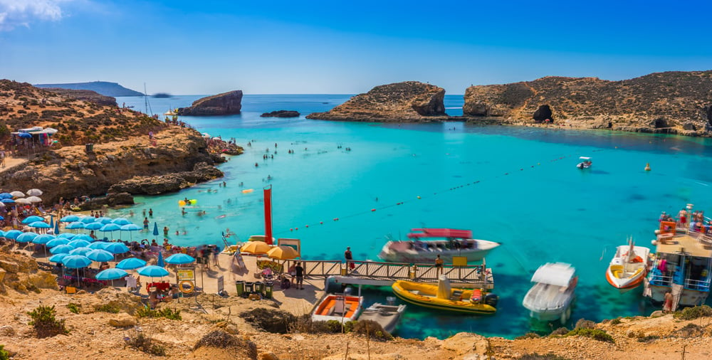 Tourists at Blue Lagoon enjoying the beach, Comino Island, Malta Holidays