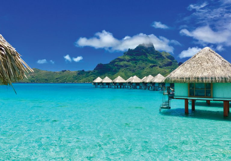 Overwater bungalows of a luxury resort providing a view of the Otemanu, Bora Bora, Tahiti, French Polynesia