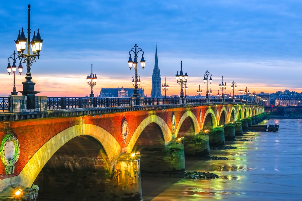 Pont de Pierre stone bridge at sunset in Bordeaux, France 