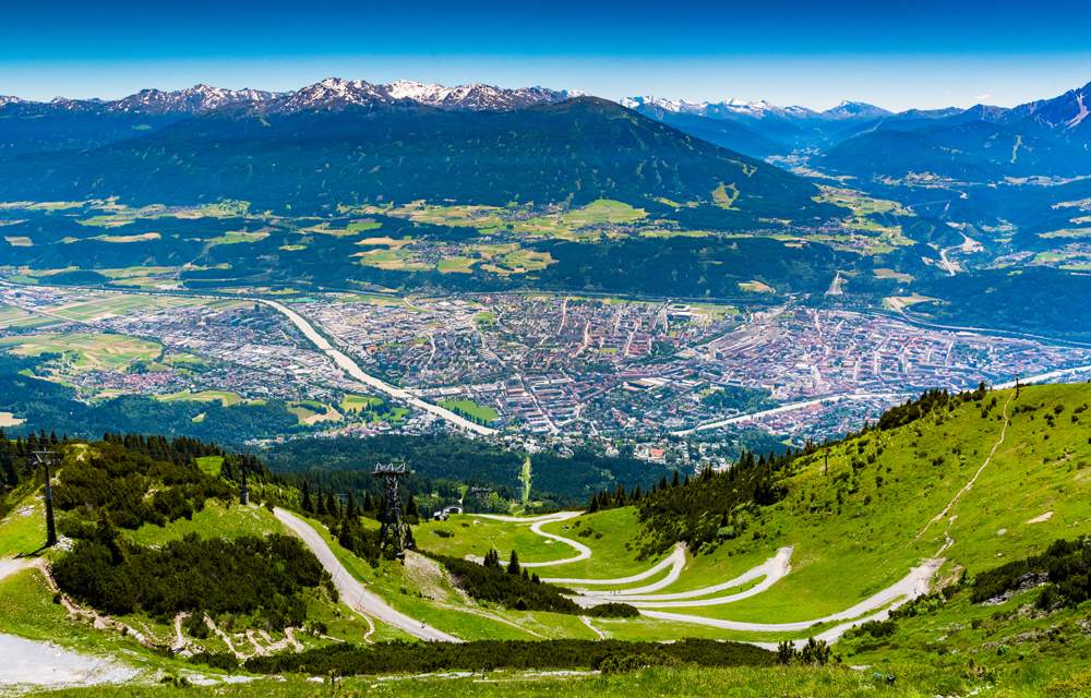 View of Innsbruck city with the Alps mountain range and cable car taken from Nordkette mountain, Austria 