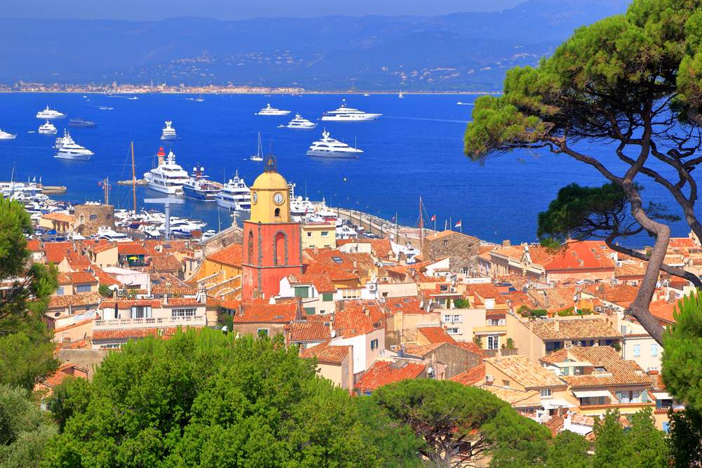 Aerial view to the old town and distant boats in Saint Tropez, France 