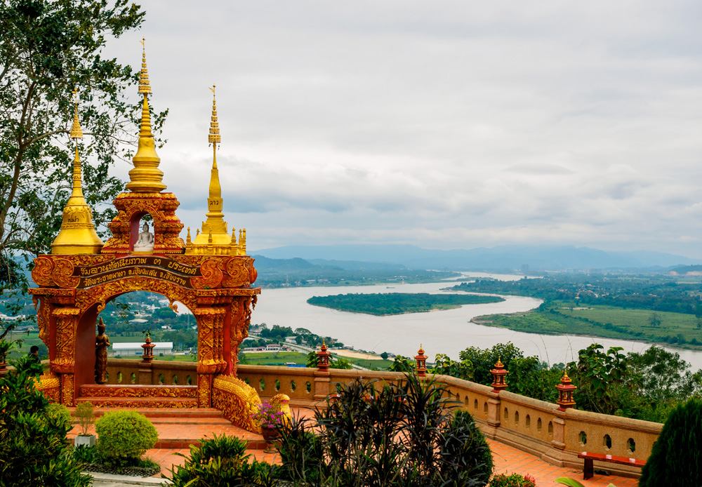 Arch with 3 golden pagodas representing Thailand, Myanmar, Laos at Pra Thad Pha Ngo Temple, Chang Saen, Thailand Vacations