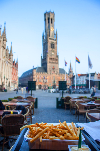 Fries with Bell Tower and Market Square in background, Bruges, Belgium 