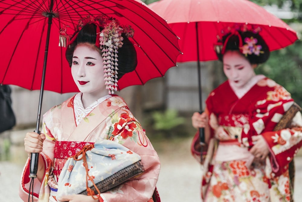 Maiko geisha walking on a street in Gion District, Kyoto, Japan