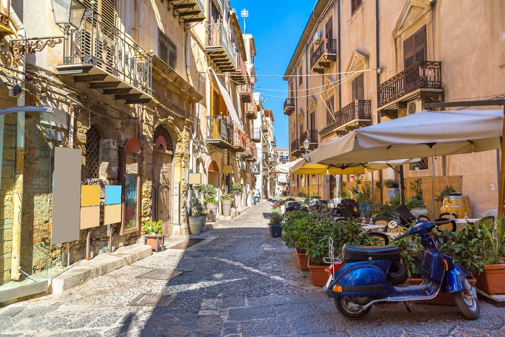 Narrow street in the old town of Cefalu in Sicily, Italy 