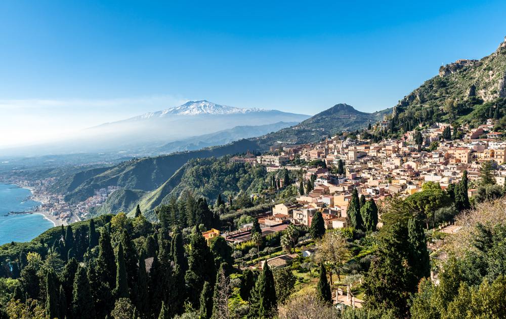 Panoramic view from Teatro Greco of Taormina, Giardini Naxos and Mount Etna in Sicily, Italy 