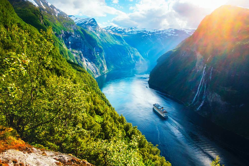 Sunnylvsfjorden Fjord with cruise ship and famous Seven Sisters waterfalls, near Geiranger village, Norway