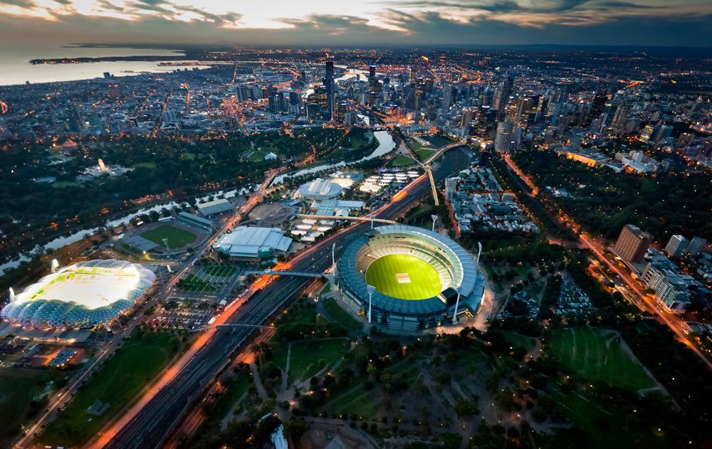 Aerial view of Melbourne skyline at dusk with Melbourne Cricket Stadium and grounds, Victoria, Australia 