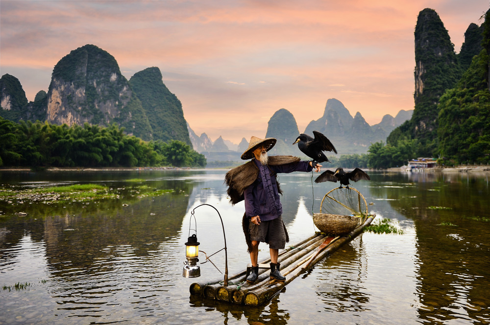Fisherman of Guilin, Li River and Karst mountains during the blue hour of dawn, China