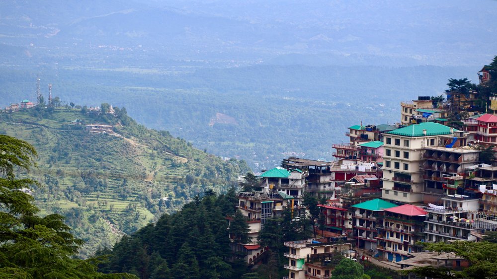 Kangra Valley and mountain homes from Upper Dharamshala on a sunny summer day, India 