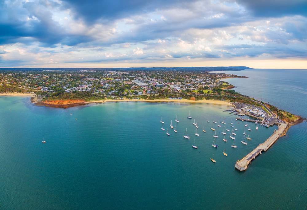 Aerial panorama of Mornington Peninsula coastline and Mornington Pier at sunset, Melbourne, Victoria, Australia 