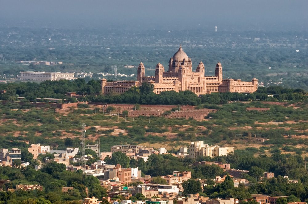 View of the blue city of Jodhpur and Umaid Bhawan Palace, India 