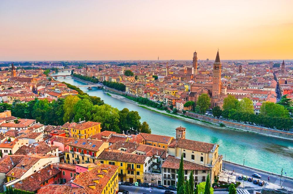 Aerial view of the historic city centre along Adige river at sunset in Verona, Italy 