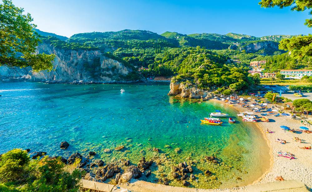 Beautiful beach and boat in Paleokastritsa, Corfu island, Ionian Islands, Greece 