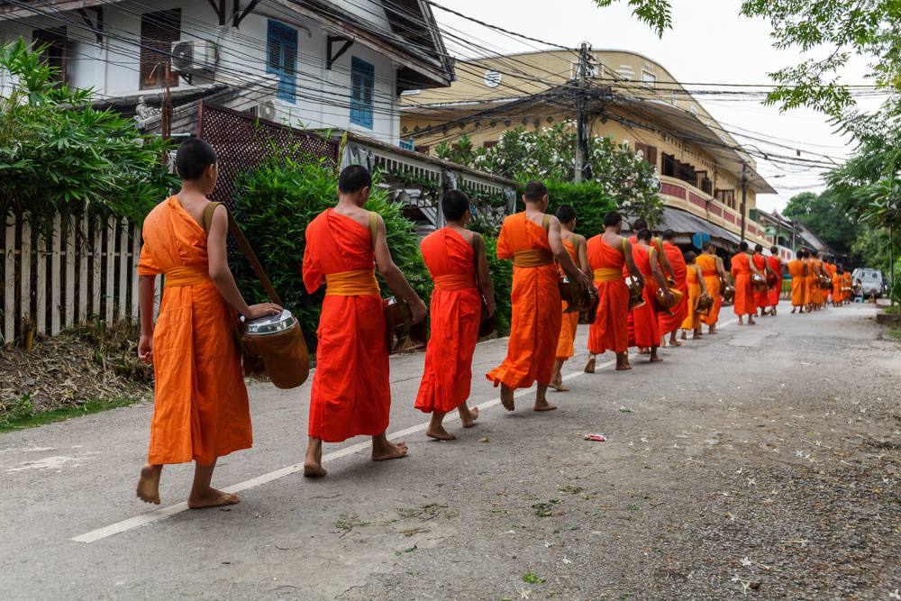 Buddhist monks in a line in Luang Prabang, Laos