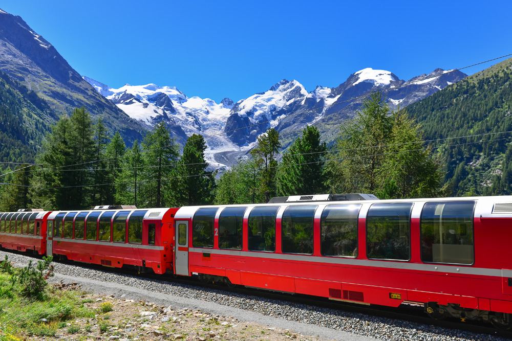 Bernina Express crossing the Alps with glaciers in the background, Switzerland 