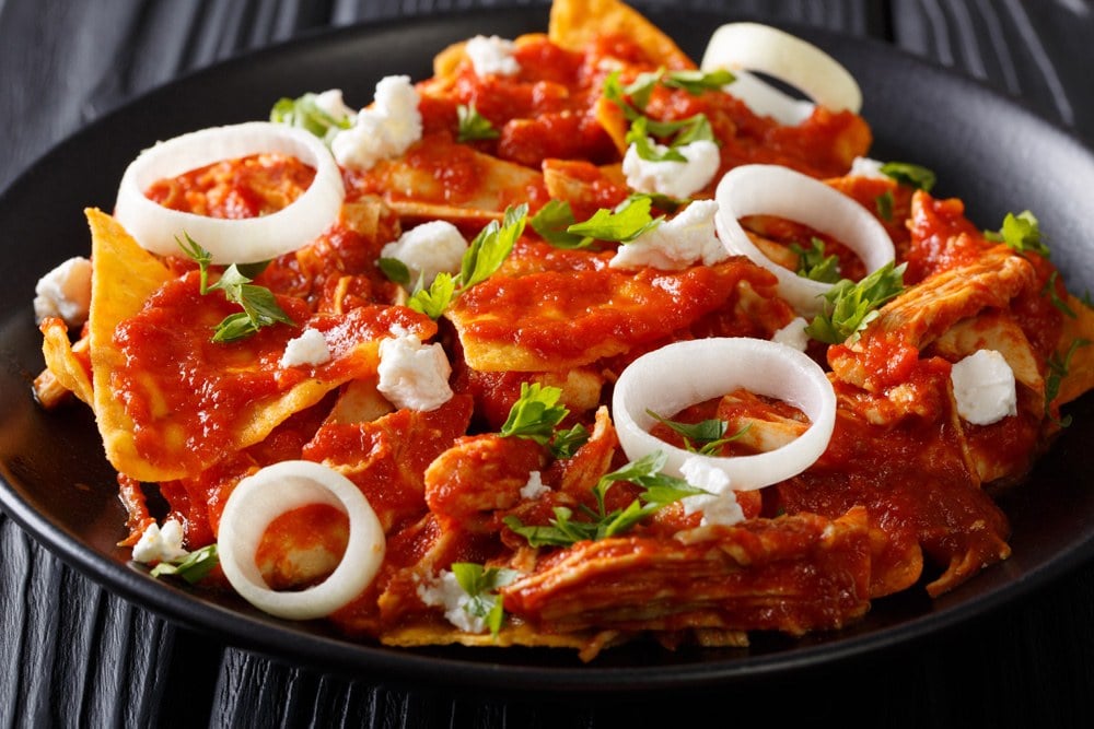 Chilaquiles, a Mexican breakfast dish of nachos with various toppings, Mexico 