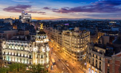 View of the Metropolis Building and Gran Via from Circulo de Bellas Artes rooftop at sunset, Madrid, Spain
