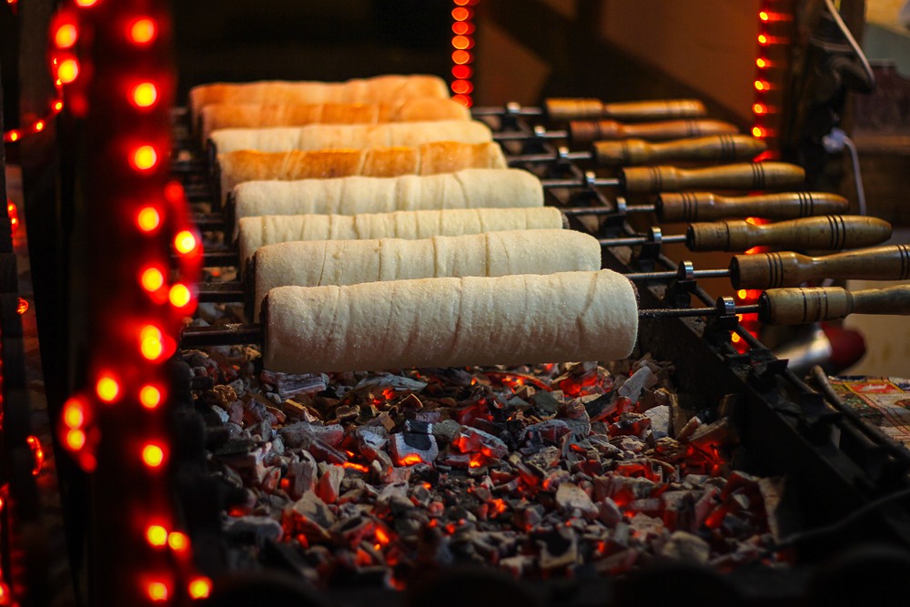 Chimney cakes baking over hot coals at a Christmas market stand in Budapest, Hungary 