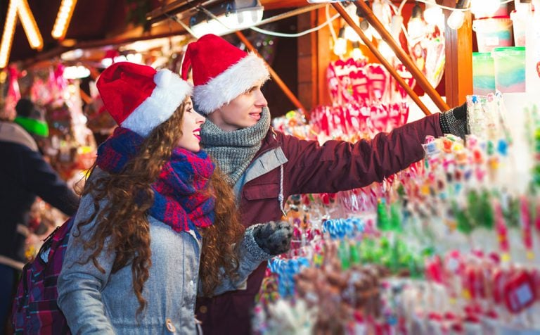 Young couple shopping at Christmas market in Germany