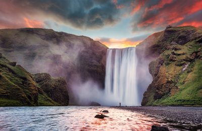Skogafoss waterfall with colourful sky during sunset and Skoga river, Iceland
