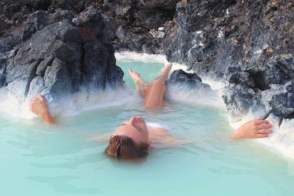 Woman floating on her back in Blue Lagoon, Iceland 