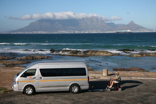 Accessible-Africa-Safaris-Man-in-Wheelchair-in-Front-of-Table-Mountain-Cape-Town-South-Africa-768x512